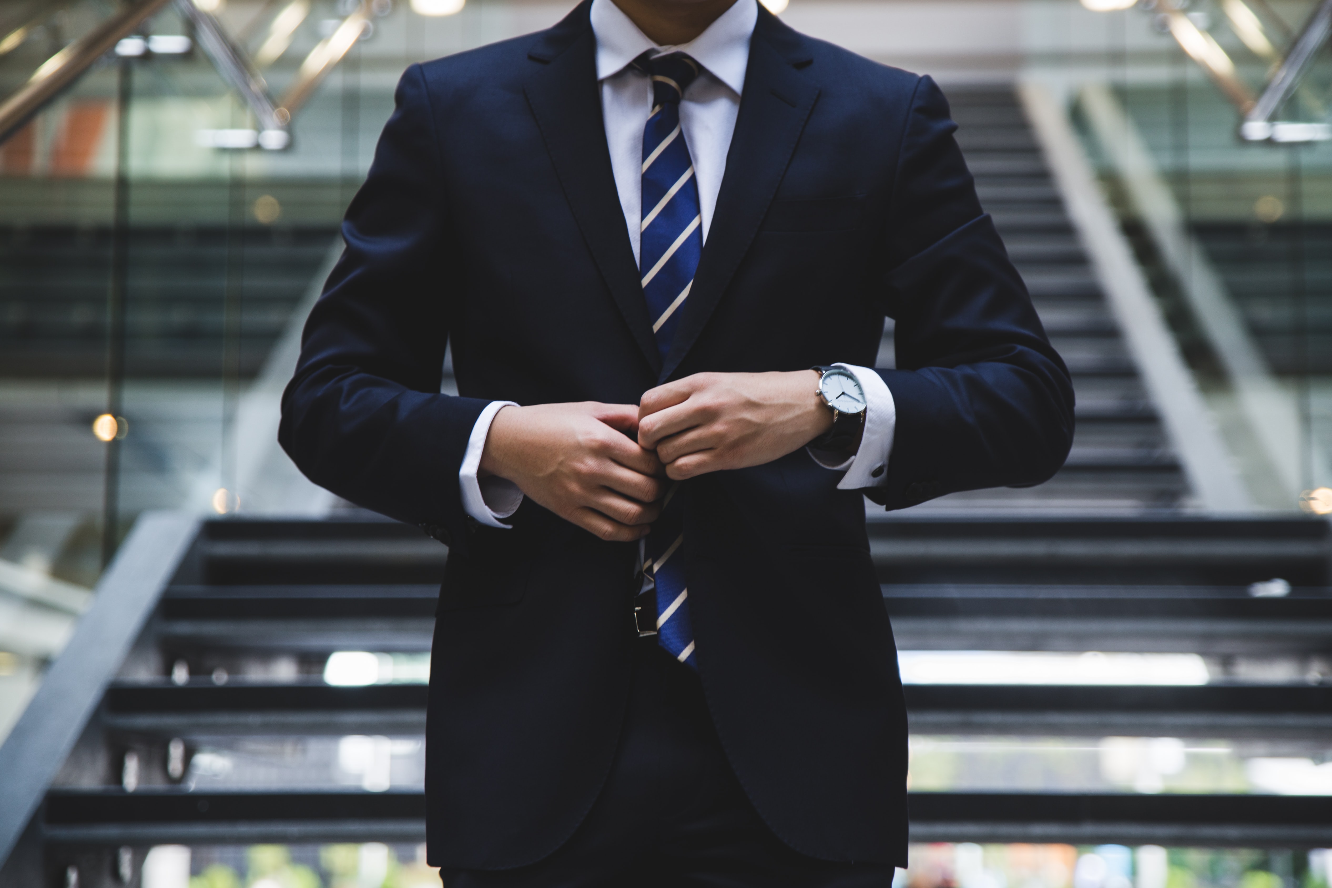 black suit walking down stairs